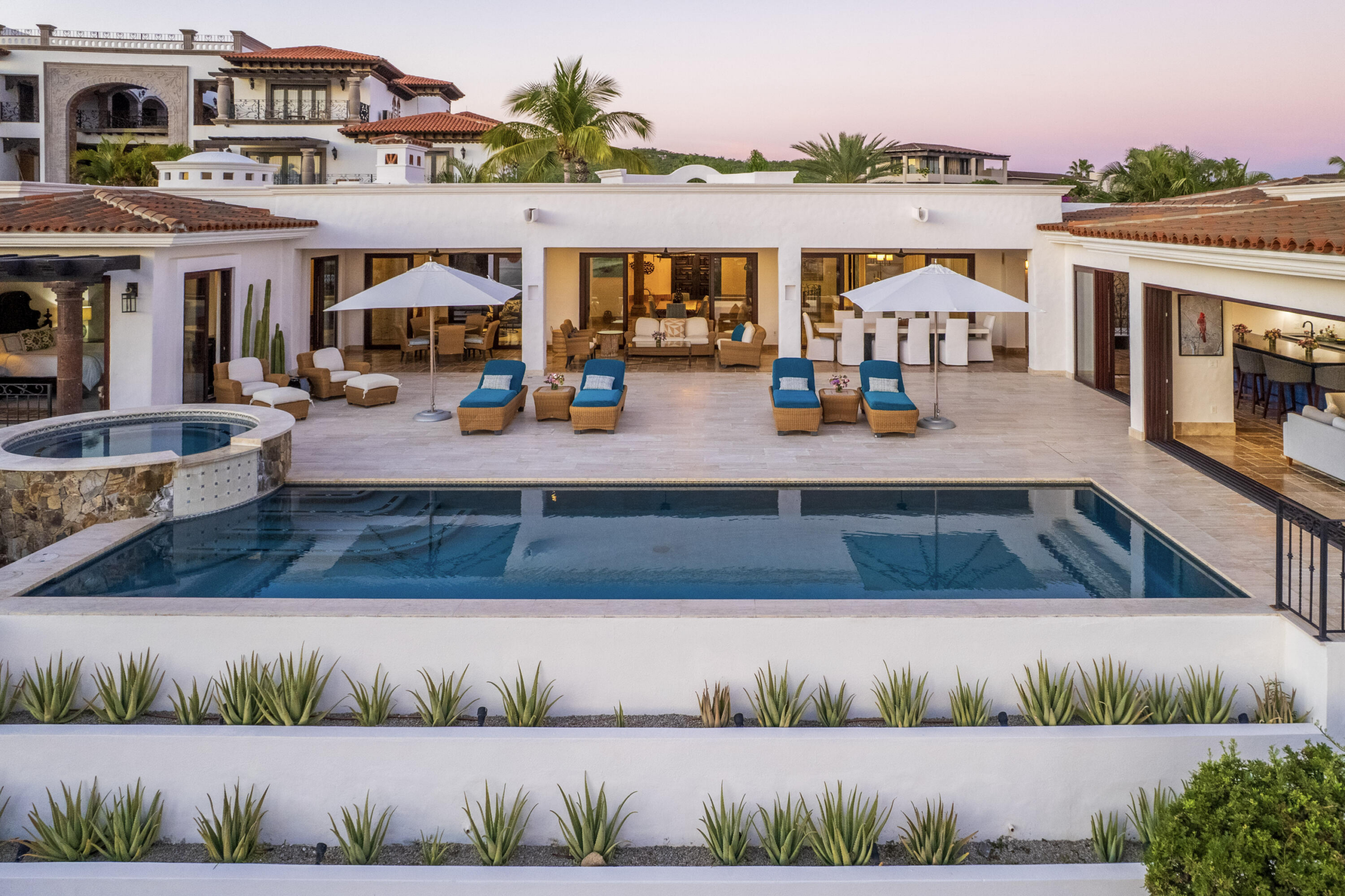 Puerto Los Cabos Fundadores Fully remodeled with entertaining in mind, Casa Reino is a stunning Spanish Colonial-style residence located within the double-gated Fundadores community of Puerto Los Cabos. Designed for hosting extended family and friends while maintaining exceptional privacy, this custom-built home blends timeless architecture with modern luxury and efficiency.An expansive pool terrace invites relaxed lounging under the renowned Los Cabos sunshine, complemented by shaded outdoor living and dining areas and multiple interior courtyards that provide privacy for guest suites. A brand-new bar, media, and entertainment room creates the perfect setting for dinner parties and special events.The thoughtful floor plan features a luxurious master suite with soaking tub and indoor/outdoor shower, along with four private guest suites, each positioned for comfort and seclusion. Modern upgrades throughout the home include all-new plumbing, air conditioning, doors, windows, lighting, and furnishings.Designed for efficiency and convenience, Casa Reino is equipped with a solar system, solar pool heater/chiller, and solar heat pump, keeping operating costs low. Additional highlights include an oversized two-car garage with commercial refrigerator and freezer, a new laundry room with dual washer/dryer sets, and a new BBQ cook center with wet bar, icemaker, and refrigeration. The pool has been newly refinished, exterior travertine decking installed, and a complete hurricane shutter system added.Residents of Puerto Los Cabos enjoy 27 holes of Nicklaus and Norman signature golf, with the option to transfer a golf membership at the purchaser's cost. Membership also includes access to tennis and pickleball courts. Fundadores HOA fees include exclusive access to the Fundadores Beach Club, featuring an oceanfront infinity pool, Jacuzzi, fitness center, event lawn, restaurant, and spa services.Ideally located just 5 minutes from the Puerto Los Cabos Marina, 10 minutes from downtown San José del Cabo, and 30 minutes from Los Cabos International Airport, Casa Reino offers effortless access to world-class dining, shopping, and lifestyle amenities.Special Features & UpgradesSolar system in placeSolar pool heater and chillerNewly remodeled pool with new finishesNew exterior travertine deckingNew bar / media / family roomNew laundry room with double washer & dryersNew air conditioning throughoutNew furnishingsNew kitchen appliances: refrigerator, two dishwashers, ice maker, beverage fridge & drawersNew sinks and faucets in kitchenSonos sound systemNew doors and windowsNew hurricane protection systemNew interior and exterior lightingCommercial refrigerator and freezer in garageNew countertops and cabinetry in kitchenette and bath at Guest Casita #4 – 218 Padre Piccolo, San Jose del Cabo, BS